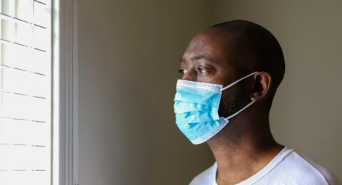 An African-American man wearing a protective face mask to prevent virus infection